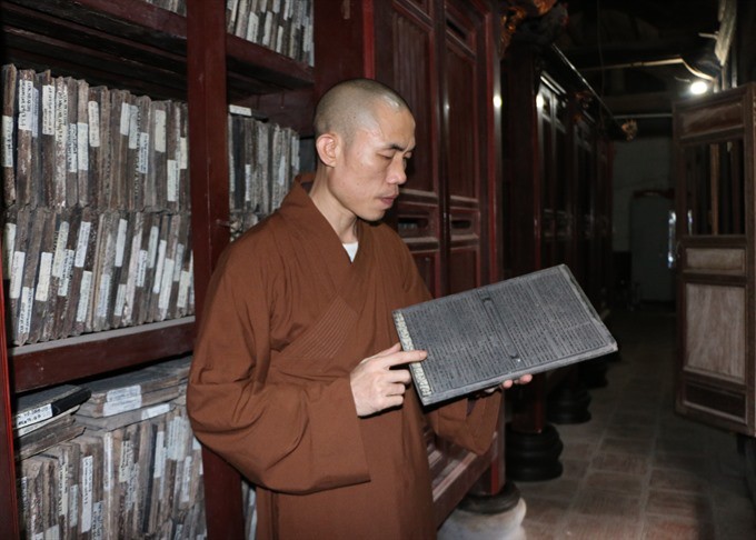 Keeping a check: The Venerable Thích Thanh Vịnh checks the woodblocks that have been recognised by UNESCO as World Documentary Heritage items as part of the Memory of the World Programme, to make sure they are preserved well. (Photo: VNS) Keeping a check: The Venerable Thích Thanh Vịnh checks the woodblocks that have been recognised by UNESCO as World Documentary Heritage items as part of the Memory of the World Programme, to make sure they are preserved well. (Photo: VNS)