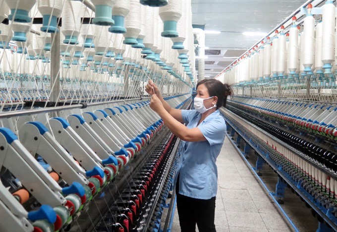 A worker operates a production line at the Nam Định Textile Garment Joint Stock Corporation. (Photo: VNA/VNS) A worker operates a production line at the Nam Định Textile Garment Joint Stock Corporation. (Photo: VNA/VNS)