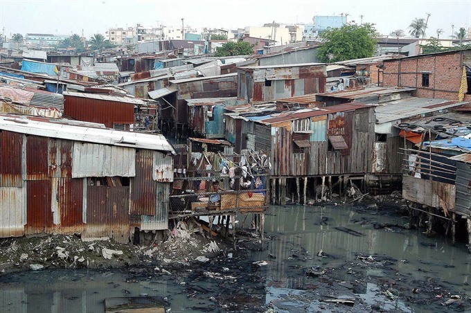 Slum in HCM City’s District 8. District 8 accounts for nearly 50 per cent of the slums with more than 1,000 houses lacking toilets and being located in severely polluted places, according to a district official. Slum in HCM City’s District 8. District 8 accounts for nearly 50 per cent of the slums with more than 1,000 houses lacking toilets and being located in severely polluted places, according to a district official.