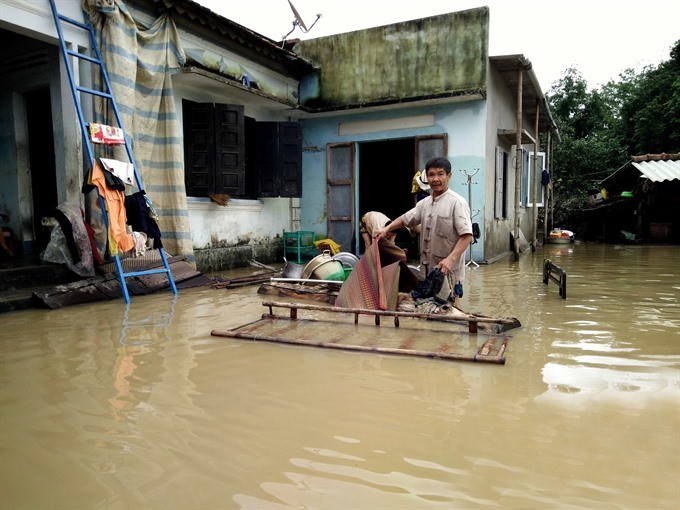 People in An Nhon commune in the south central province of Binh Dinh clean their houses as flood waters recede. People in An Nhon commune in the south central province of Binh Dinh clean their houses as flood waters recede.