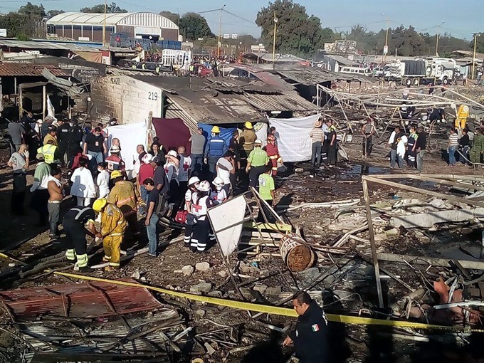 A handout picture made available by the Mexican Red Cross on Wednesday shows members of the Red Cross working at the site of an explosion at a fireworks market in the municipality of Tultepec, Mexico. According to State of Mexico governor Eruviel Avila, the number of people killed after several explosions rocked the fireworks market has A handout picture made available by the Mexican Red Cross on Wednesday shows members of the Red Cross working at the site of an explosion at a fireworks market in the municipality of Tultepec, Mexico. According to State of Mexico governor Eruviel Avila, the number of people killed after several explosions rocked the fireworks market has