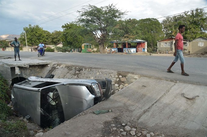 A car damaged by a bus lies on the side of a road in Gonaives. 38 people were killed in the accident. — AFP/VNA Photo A car damaged by a bus lies on the side of a road in Gonaives. 38 people were killed in the accident. — AFP/VNA Photo