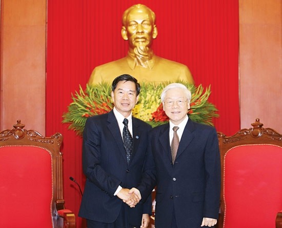 General Secretary of Party Committee of Vietnam Nguyen Phu Trong (R) receives Party Secretary and Lord Mayor of Vientiane Sinlavong Khoutphaythoune.
