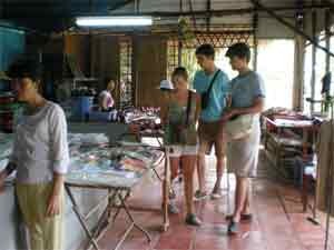 Foreign torurists choose goods at a handicraft shop Foreign torurists choose goods at a handicraft shop