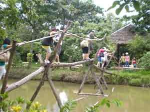 Tourists walk across a "monkey bridge" with a thrill Tourists walk across a "monkey bridge" with a thrill