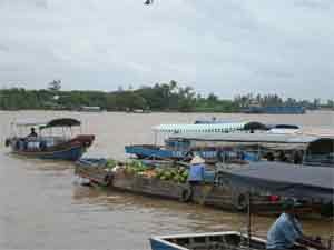 Boats loaded with goods and fruit anchored close together at the Tien riverside Boats loaded with goods and fruit anchored close together at the Tien riverside