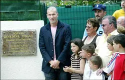 Zidane bên cạnh tấm biển đồng mang tên anh đặt ở quảng trường Zidane bên cạnh tấm biển đồng mang tên anh đặt ở quảng trường