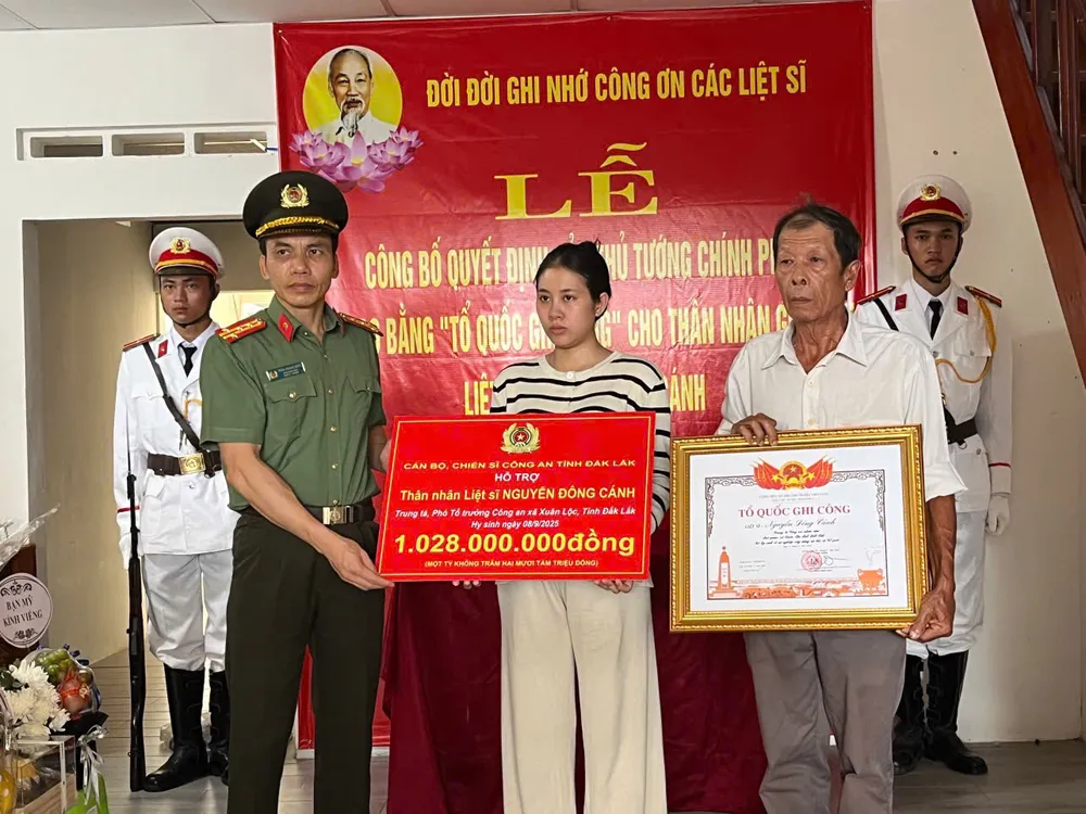 Đại tá Trần Quang Hiếu trao bằng Tổ Quốc ghi công và số tiền hỗ trợ của cán bộ, chiến sĩ Công an tỉnh Đắk Lắk cho thân nhân liệt sĩ Nguyễn Đông Cánh z7001198136486_7b9b2454a7af46817960d5b6c6376c7c.jpg