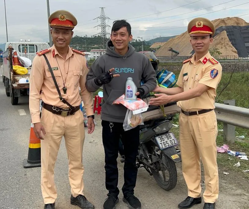 CSGT Trạm cửa ô Hòa Nhơn tặng dầu nhớt, áo mưa và thức ăn cho người dân đi xe máy về quê