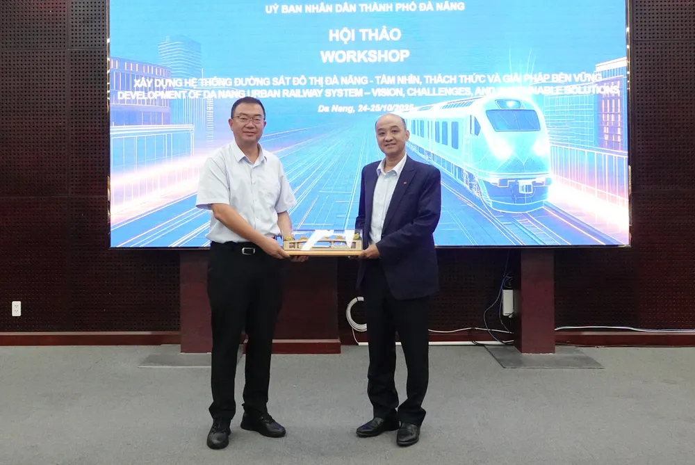 Phó Chủ tịch UBND TP Đà Nẵng Lê Quang Nam trao quà lưu niệm cho ông Lý Văn Thắng. Ảnh: XUÂN QUỲNH DSC07000.JPG