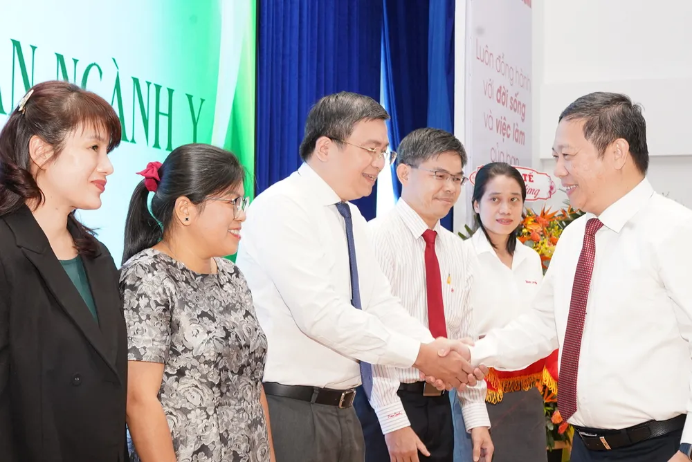 Đồng chí Dương Anh Đức chúc mừng nhóm y bác sĩ có thành tích cao trong công tác được vinh danh tại buổi lễ. Ảnh: KIM HUYỀN img-6040-1621.jpg
