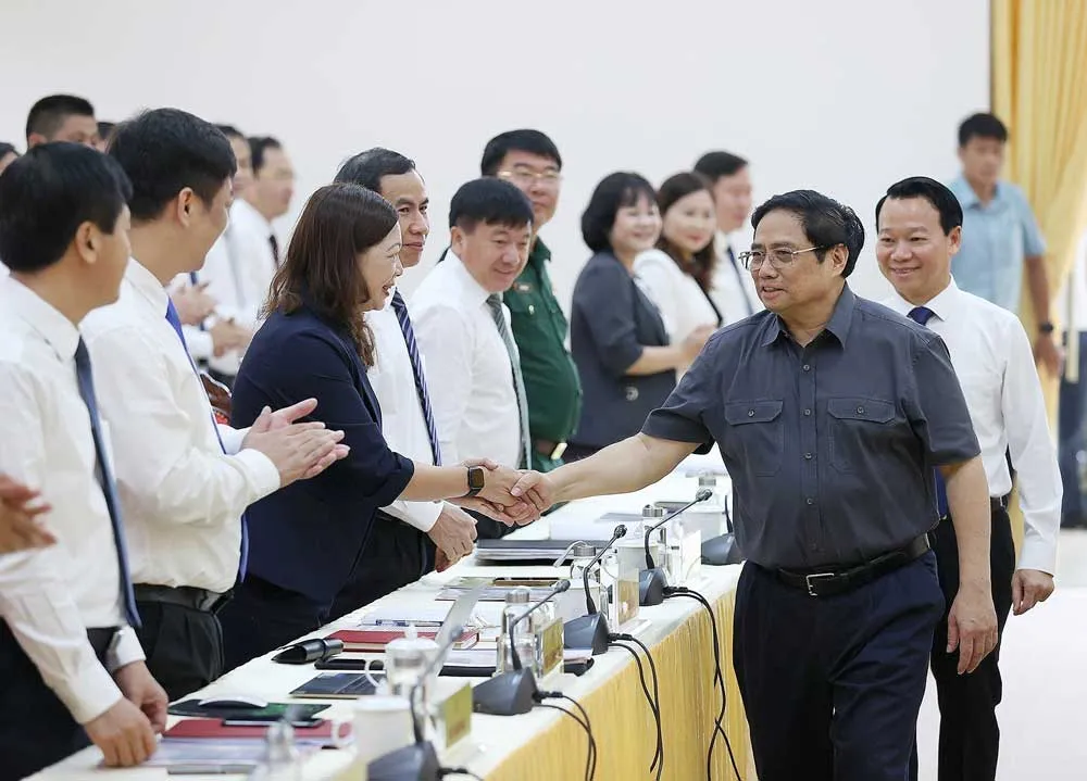 Thủ tướng Phạm Minh Chính với các đại biểu tham dự buổi làm việc. Ảnh: TTXVN