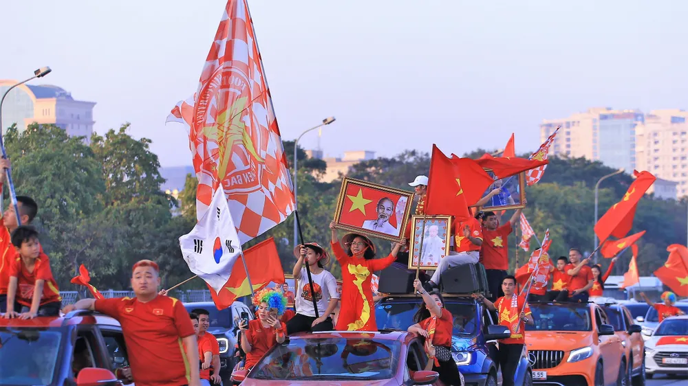 Tương tự các trận đấu AFF Cup 2022 đã qua của Việt Nam trên sân Mỹ Đình, một nhóm khoảng 100 CĐV đã tổ chức diễu hành quanh con đường Lê Đức Thọ - Lê Quang Đạo. Nữ CĐV nổi tiếng Nguyễn Thị Hồng Thúy khoác lên mình áo dài truyền thống in bản đồ Việt Nam và giương cao ảnh Bác Hồ.