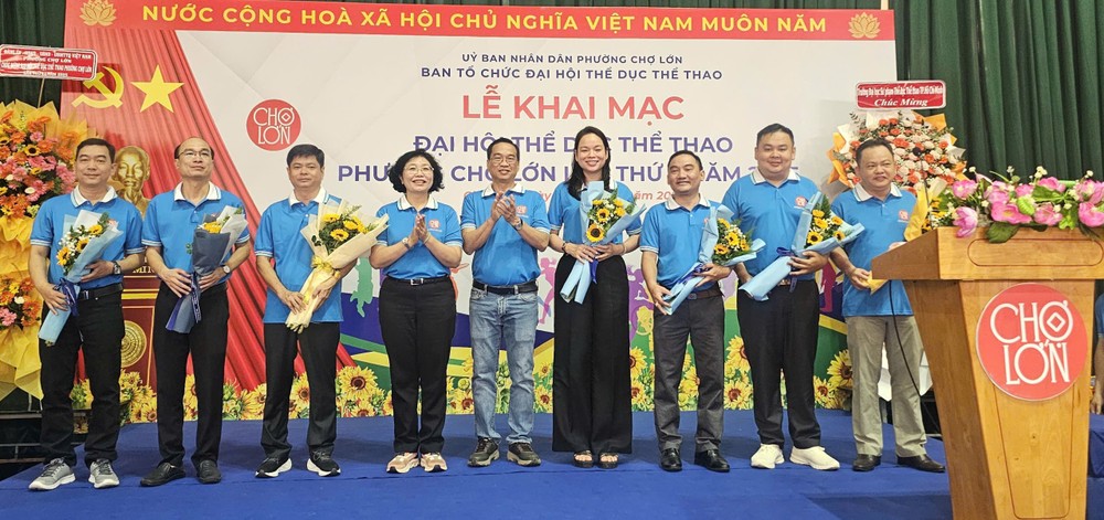 堤岸坊党部书记黄玉女芳红向第一届体育大会组委会赠送鲜花。