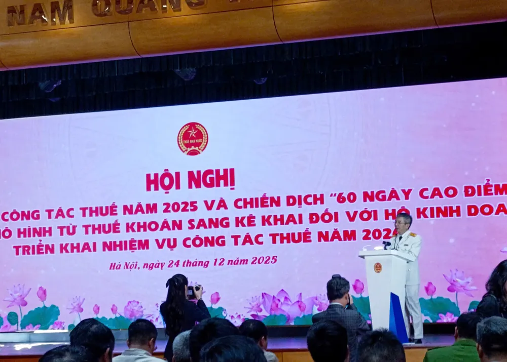 Ông Mai Xuân Thành, Cục trưởng Cục Thuế, phát biểu báo cáo tại hội nghị, chiều 24-12. Ảnh: LƯU THỦY