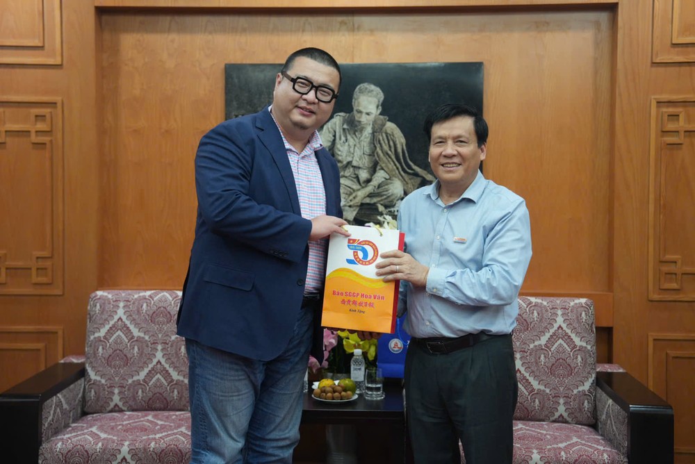 本报领导向新华通讯社河内分社赠送纪念品。