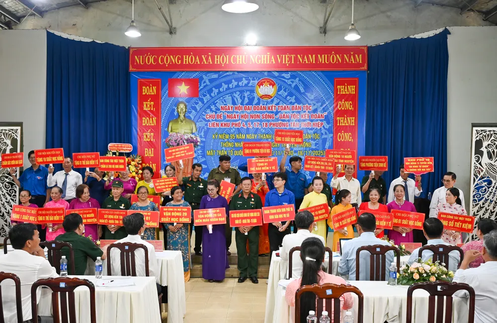 Đại diện Ban Công tác Mặt trận, các tổ chức chính trị xã hội các khu phố bên bảng tượng trưng kết quả thực hiện các cuộc vận động, phong trào thi đua yêu nước ở các địa bàn dân cư.jpg