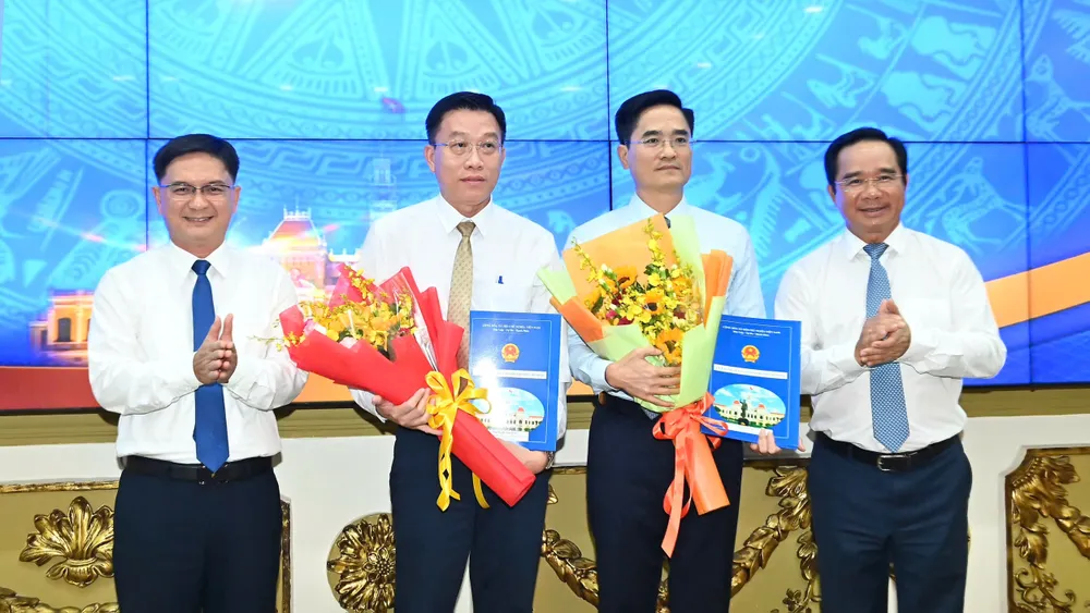 Chủ tịch UBND TPHCM Nguyễn Văn Được và Phó Chủ tịch UBND TPHCM Nguyễn Mạnh Cường trao quyết định và hoa chúc mừng đồng chí Trần Quang Lâm và đồng chí Nguyễn Anh Minh. Ảnh: VIỆT DŨNG nhansu-1609.JPG