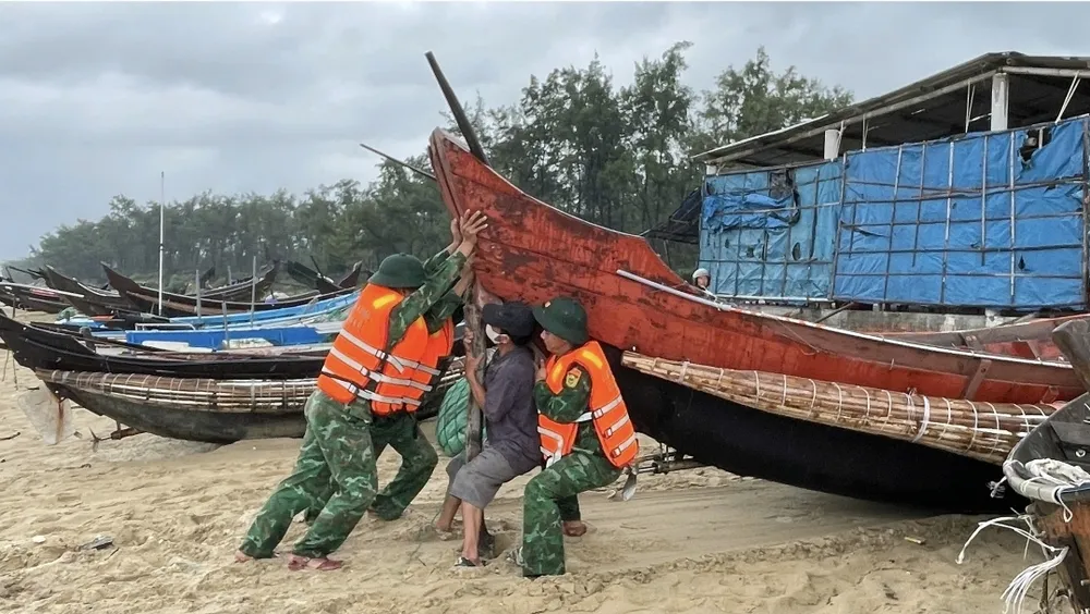 Bộ đội biên phòng TP Huế giúp ngư dân đưa thuyền lên bờ 1000026892.jpg