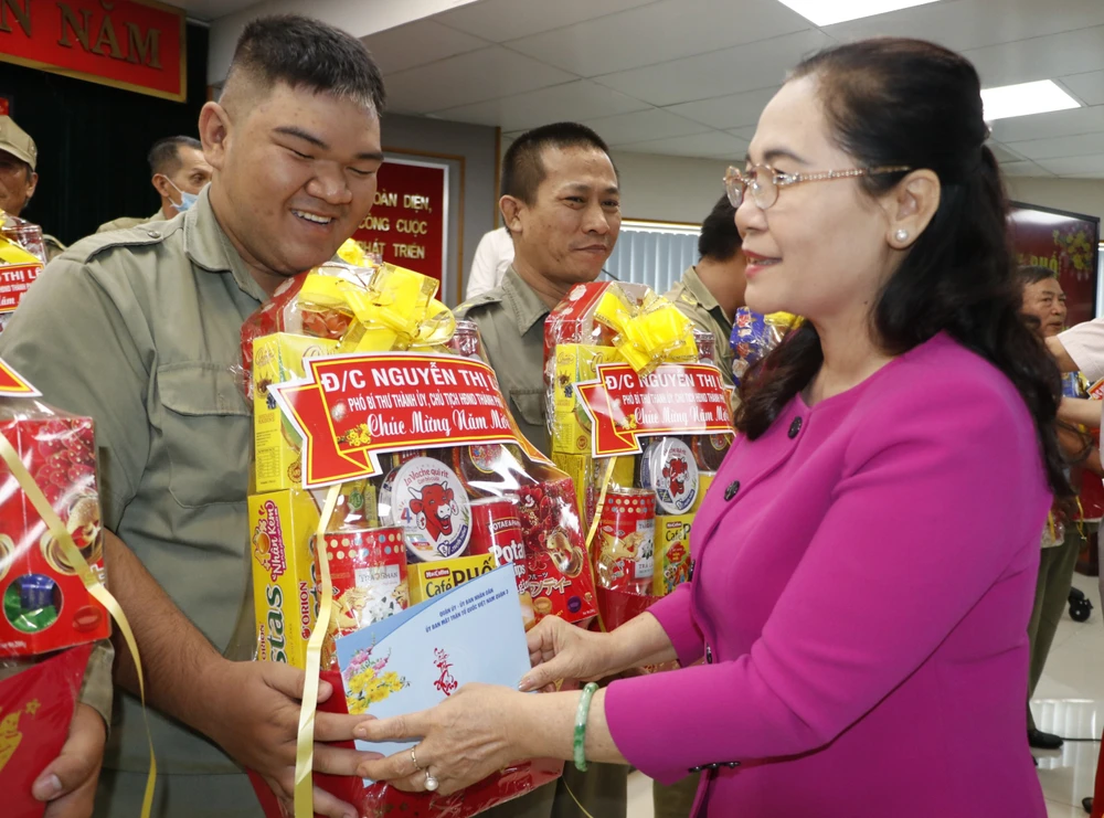 Đồng chí Nguyễn Thị Lệ tặng quà lực lượng bảo vệ dân phố có hoàn cảnh khó khăn. Ảnh: NGÔ BÌNH.