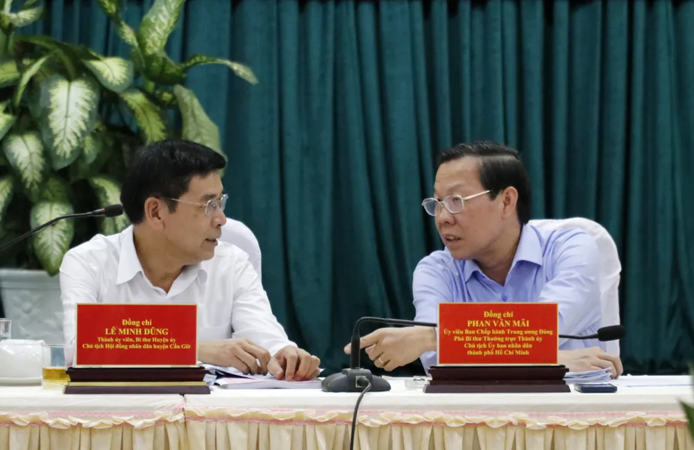 Đồng chí Phan Văn Mãi trao đổi với Bí thư Huyện ủy huyện Cần Giờ Lê Minh Dũng. Ảnh: NGÔ BÌNH