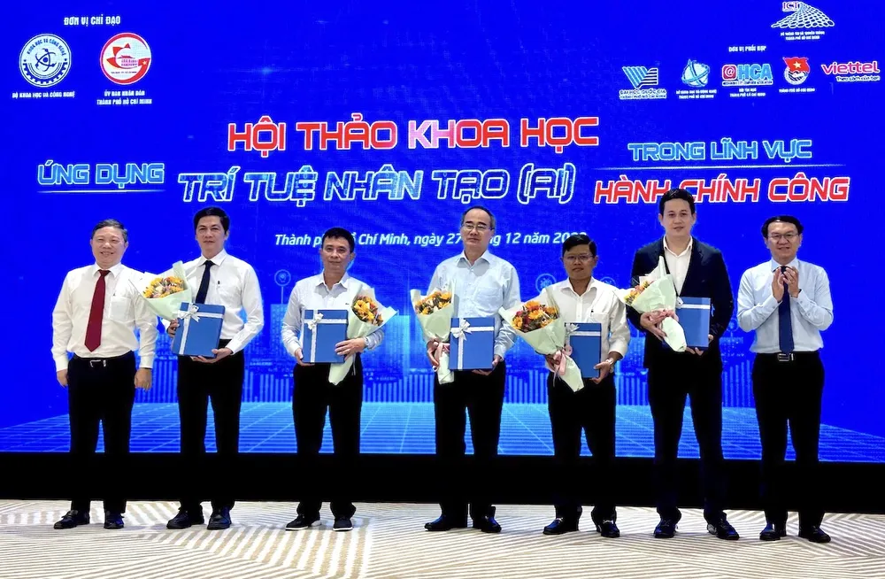 Phó Chủ tịch UBND TPHCM Dương Anh Đức và Giám đốc Sở TT-TT TPHCM Lâm Đình Thắng trao hoa cho các đại biểu dự hội thảo