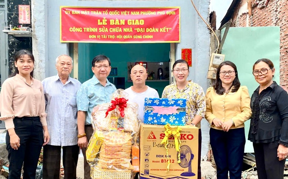 在移交仪式上，富定坊越南祖国阵线委员会领导和崇正慈善会馆代表等与户主朱国林合照。