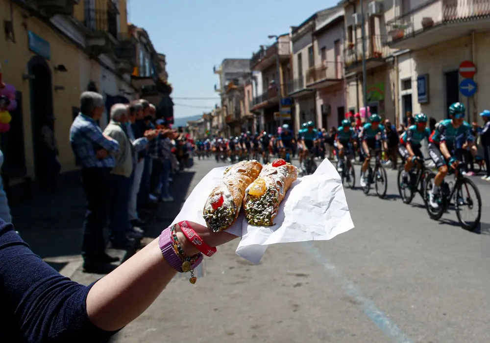 Người hâm mộ chào mừng đoàn đua bằng đặc sản địa phương