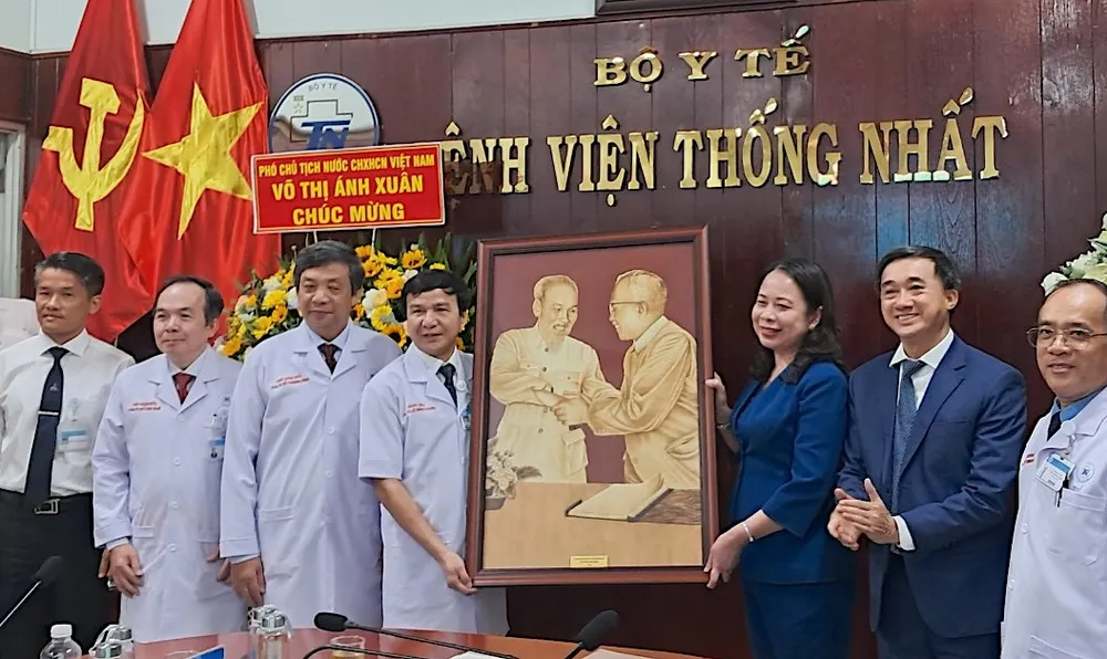 Phó Chủ tịch nước Võ Thị Ánh Xuân trao tặng bức tranh "Bác Hồ - Bác Tôn" cho Ban Giám đốc Bệnh viện Thống Nhất TPHCM. Ảnh: QUANG HUY z5193300057540-aaaf755e3aa189b0679edcd4e44c6990-8876.jpg