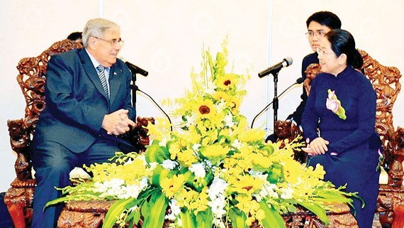Vice Secretary of HCMC Party Committee Vo Thi Dung (R) receives Jean Charles Negre, Politburo member and former standing member of the French Communist Party (PCF) Secretariat on April 26 