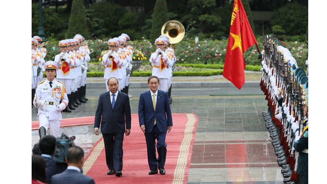 Japanese Prime Minister Yoshihide Suga gets a red carpet welcome.