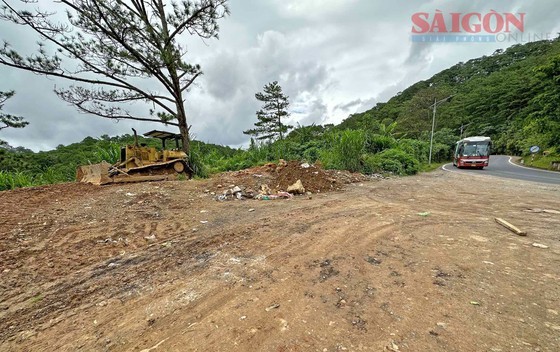 A bulldozer pushes garbage, soil, and construction waste down the hill. A bulldozer pushes garbage, soil, and construction waste down the hill.
