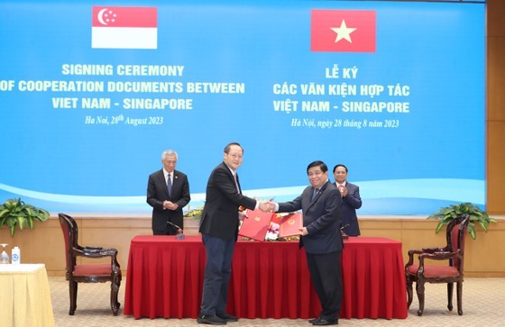 Vietnamese Minister of Planning and Investment Nguyen Chi Dung (R), and Singaporean Minister of Industry and Trade cum Minister of Manpower Tan See Leng sign a diplomatic note on amending the connectivity framework agreement, signed by the two Governments in 2005. (Photo: SGGP) Vietnamese Minister of Planning and Investment Nguyen Chi Dung (R), and Singaporean Minister of Industry and Trade cum Minister of Manpower Tan See Leng sign a diplomatic note on amending the connectivity framework agreement, signed by the two Governments in 2005. (Photo: SGGP)