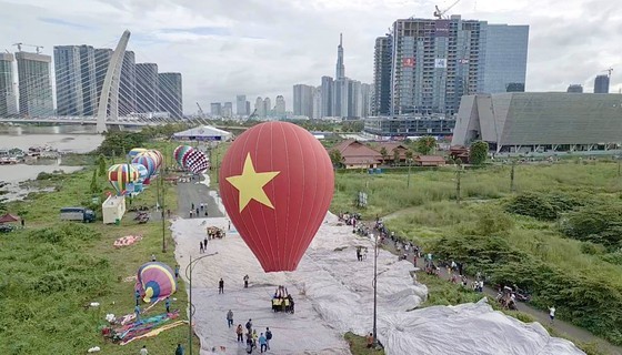 A hot-air balloon with a height of 18 meters and a diameter of 14 meters carrying a national flag flying high in the sky over HCMC (Photo: SGGP) A hot-air balloon with a height of 18 meters and a diameter of 14 meters carrying a national flag flying high in the sky over HCMC (Photo: SGGP)