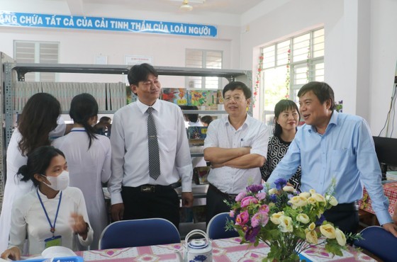 Editor-in-chief of the SGGP Newspaper Tang Huu Phong (R) talks with teachers and students of the Ninh Thanh Loi High School (Photo: SGGP)