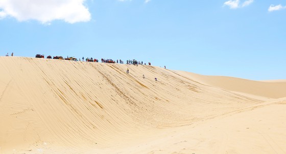 Off-road vehicles crossing sand dunes