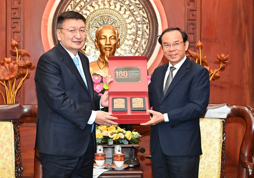 Secretary of the Ho Chi Minh City Party Committee Nguyen Van Nen (R) offers a gift to General Secretary of the Mongolian People's Party (MPP) Yangug Sodbaatar. (Photo: SGGP) 1000003678-8375-2660.jpg.jpg