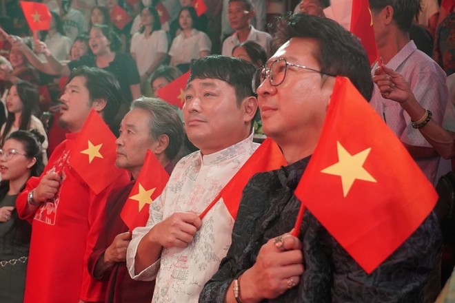 The production crew from the RoK wearing Ao dai, holding the Vietnamese national flag watching the show. From right to left: artistic director Park Hyun Woo, director Cho Joon Hui (Vietnam National Drama Theater) e-kip-san-xuat-tu-han-quoc-mac-ao-dai-cam-quoc-ky-viet-nam-xem-chuong-trinh-tu-phai-qua-thu-nhat-la-giam-doc-nghe-thuat-park-hyun-woo-thu-hai-la-dao-dien-cho-joon-hui-anh-nha-hat-kich-viet-nam.jpg