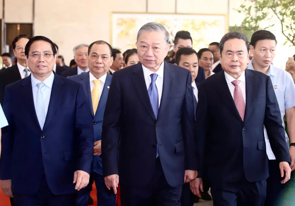 Party General Secretary To Lam (C), Prime Minister Pham Minh Chinh (L), and National Assembly Chairman Tran Thanh Man (R), along with delegates, attend the opening ceremony of the exhibition. (Photo: SGGP) 1.jpg