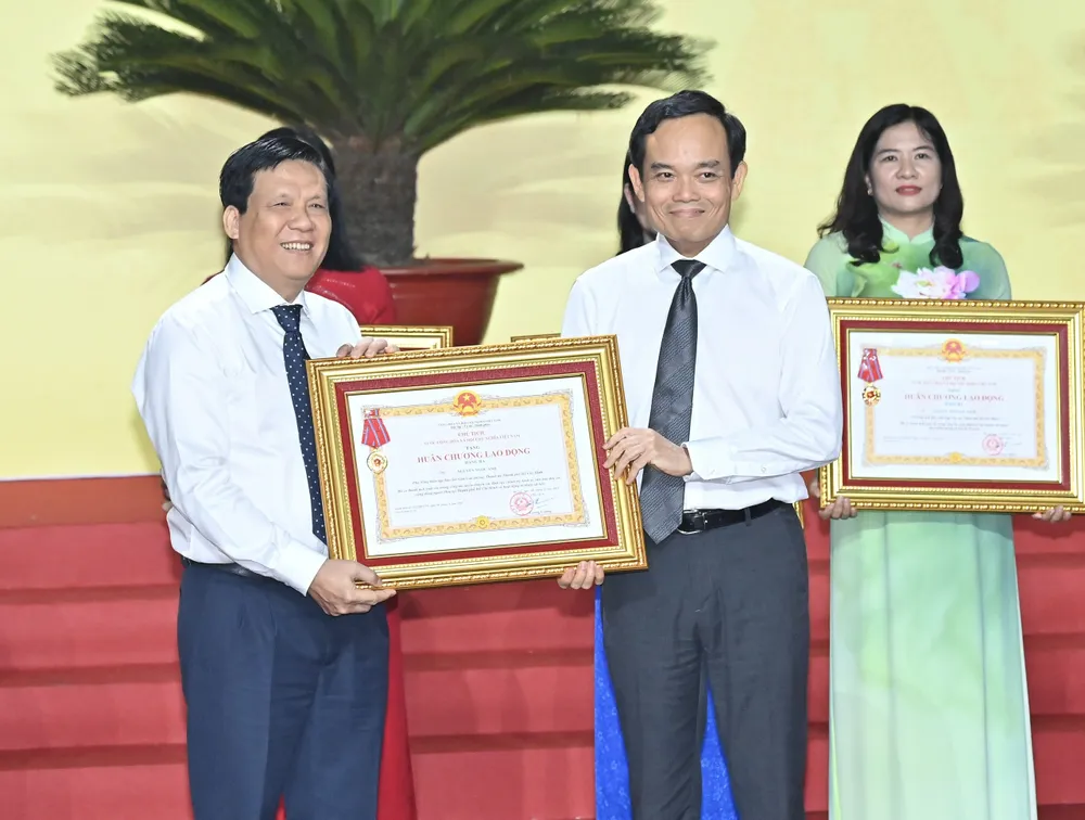 Bí thư Thành ủy TPHCM Trần Lưu Quang trao Huân chương Lao động hạng ba đến ông Nguyễn Ngọc Anh, Phó Tổng Biên tập Báo Sài Gòn Giải Phóng. Ảnh: VIỆT DŨNG Anh VD 13.jpg