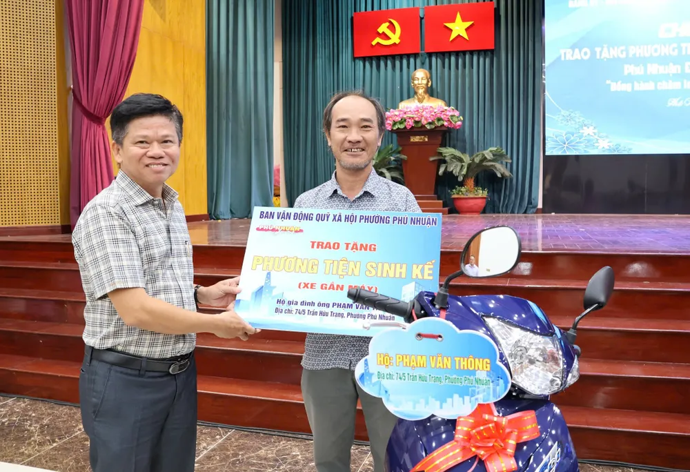 Chủ tịch Ủy ban MTTQ Việt Nam phường Phú Nhuận Đinh Gia Huỳnh trao phương tiện sinh kế đến người dân có hoàn cảnh khó khăn
