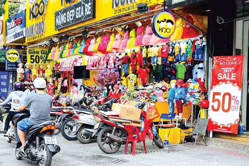 Hàng khuyến mại giảm giá cuối năm trưng bày tất cả các đường phố.Ảnh: LONG THANH