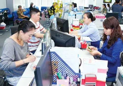 Khách hàng giao dịch tại Eximbank. Ảnh: LONG THANH