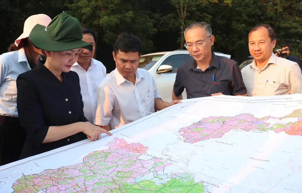 Bí thư Tỉnh ủy Bình Phước Tôn Ngọc Hạnh (trái) khảo sát khu vực dự kiến làm cầu Mã Đà kết nối với tỉnh Đồng Nai Ảnh: BÙI LIÊM