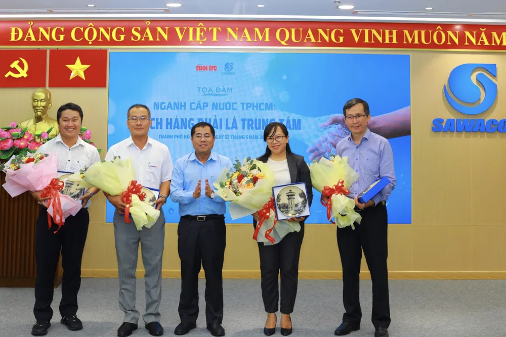 H2- Ông Dương Hồng Nhân, Bí thư Đảng ủy SAWACO  tặng hoa đến các đại biểu tham gia tọa đàm. Ảnh ĐINH BÍCH.jpg