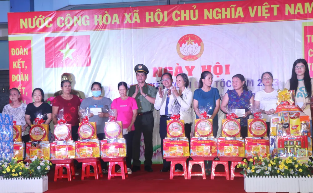 Trung tướng Lê Hồng Nam và đồng chí Phạm Minh Tuấn trao quà cho các hộ gia đình có hoàn cảnh khó khăn ở khu phố 6. Ảnh: THU HOÀI