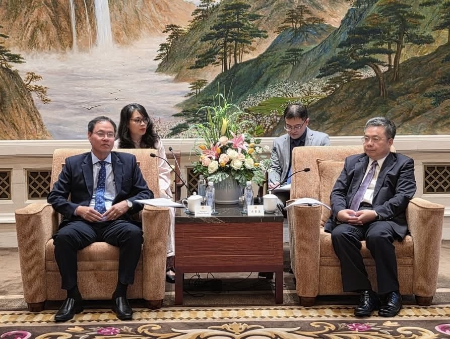 胡志明市越南祖国阵线委员会副主席阮成忠（左）会见中国上海市政协副主席肖贵玉。
