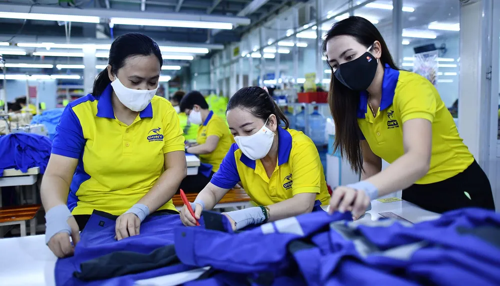 Công nhân Công ty TNHH may mặc Dony (huyện Bình Chánh, TPHCM) kiểm tra sản phẩm. Ảnh: NGÔ BÌNH