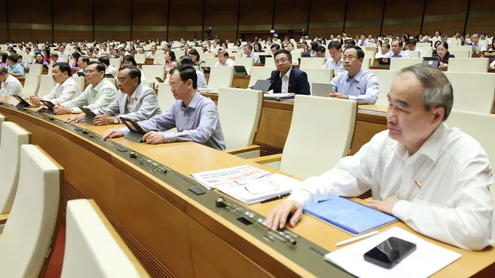 Đại biểu Quốc hội bấm nút biểu quyết thông qua luật, sáng 16-6. Ảnh: QUANG PHÚC