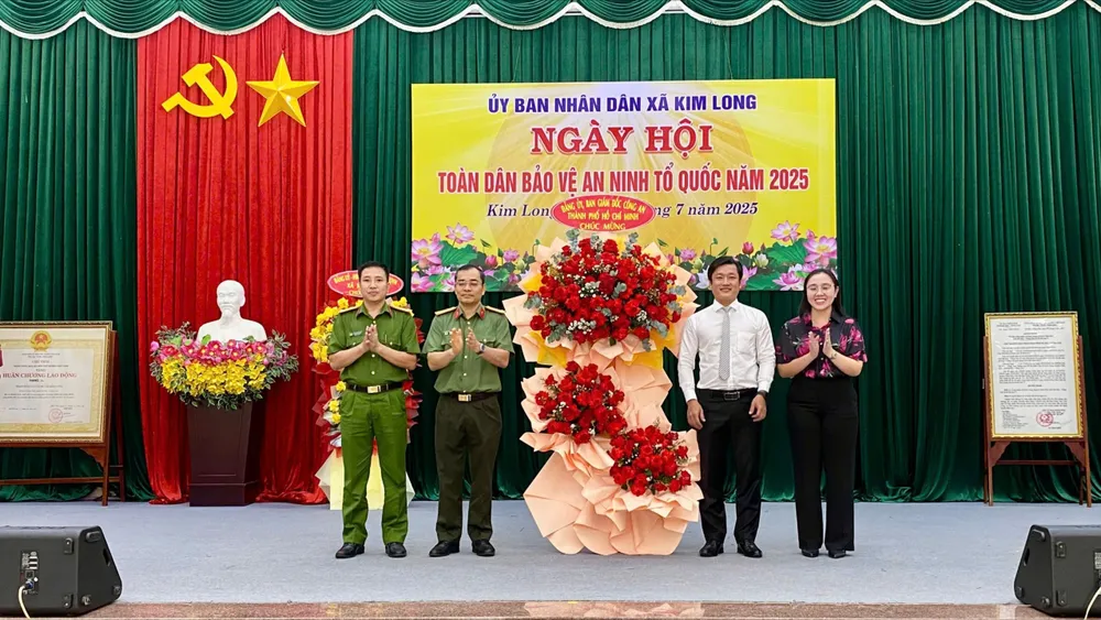 Đại tá Lê Quang Đạo, Phó Giám đốc Công an TPHCM tặng hoa chúc mừng ngày hội. Ảnh: VĂN ANH